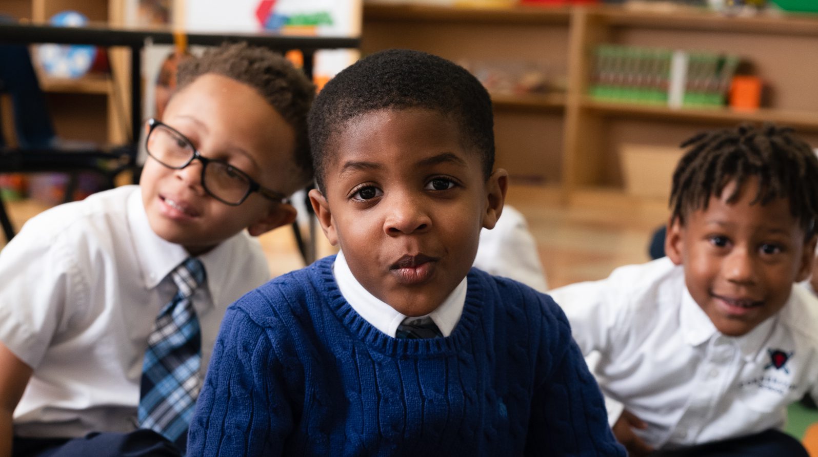 Three elementary school boys smiling